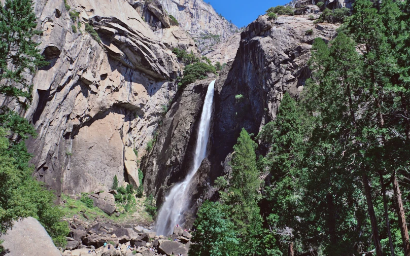 a waterfall and rocks in the wilderness