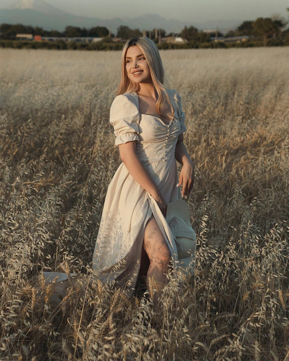 a woman dressed in historical clothing is standing in tall grass