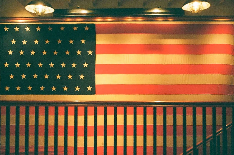 a large united states flag and stairs leading to other walls