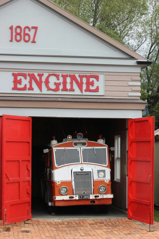 an old fire truck sitting in a garage