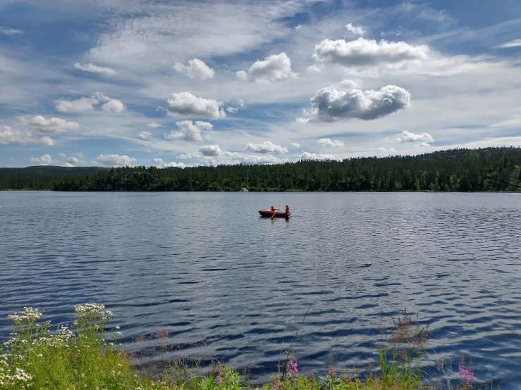 a person in a canoe paddling on the lake