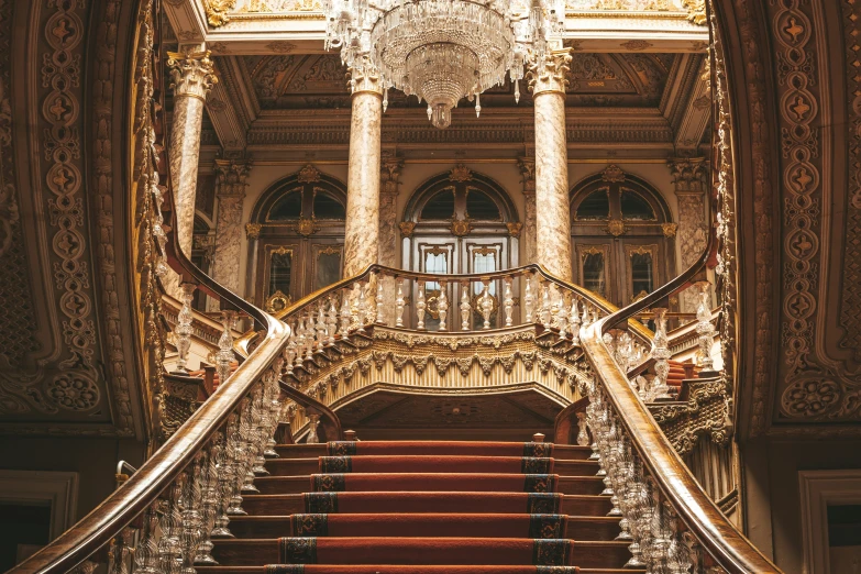 there is a large chandelier over the stairs in this building