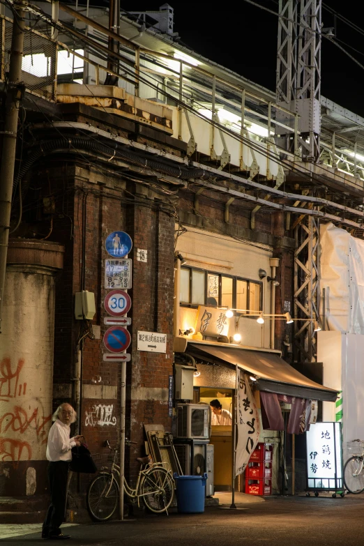 an old building that has two men standing next to it