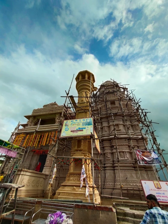 an old statue with scaffolding around it that is being constructed