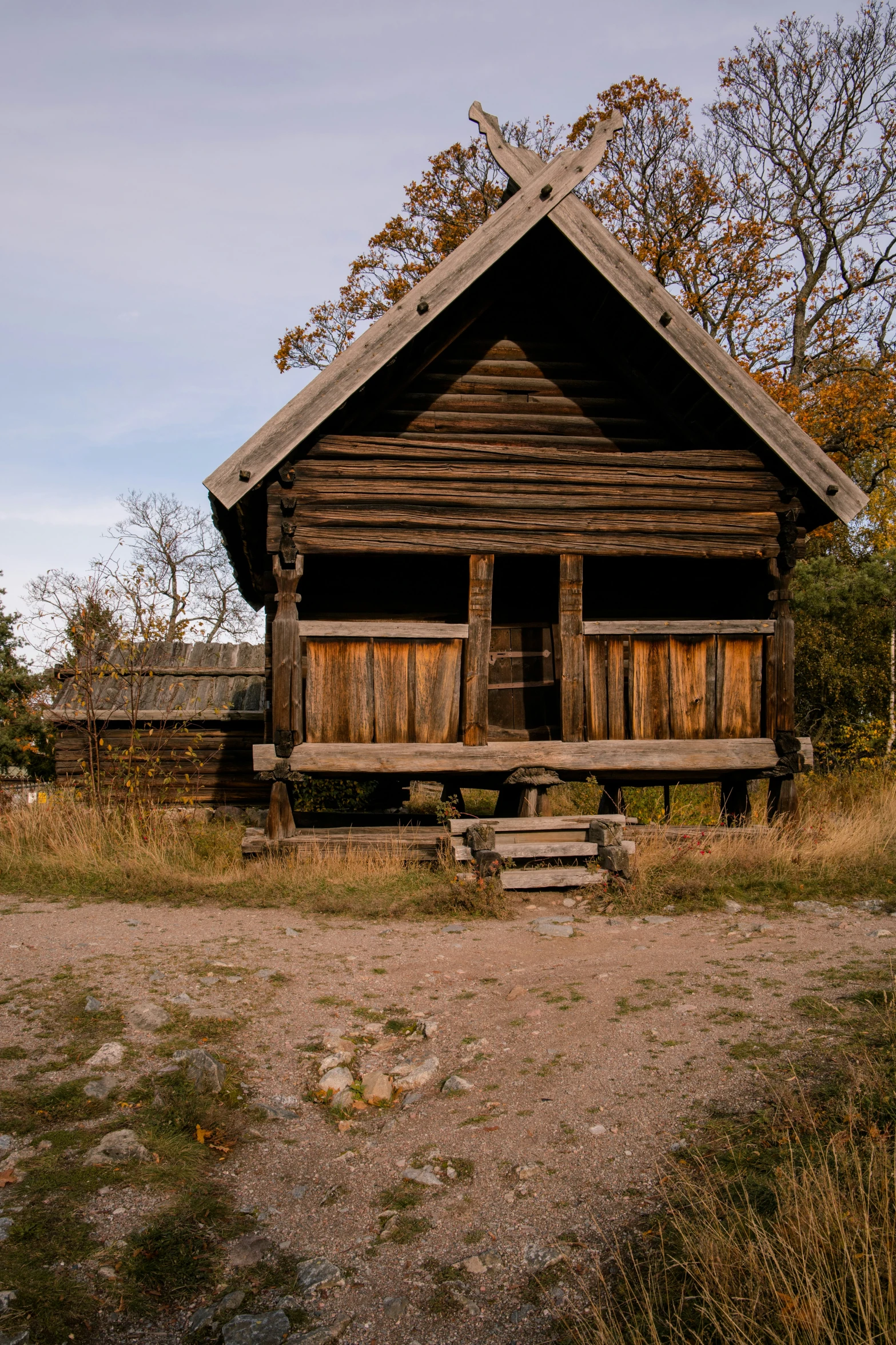 an old, run down wooden house sitting in a field