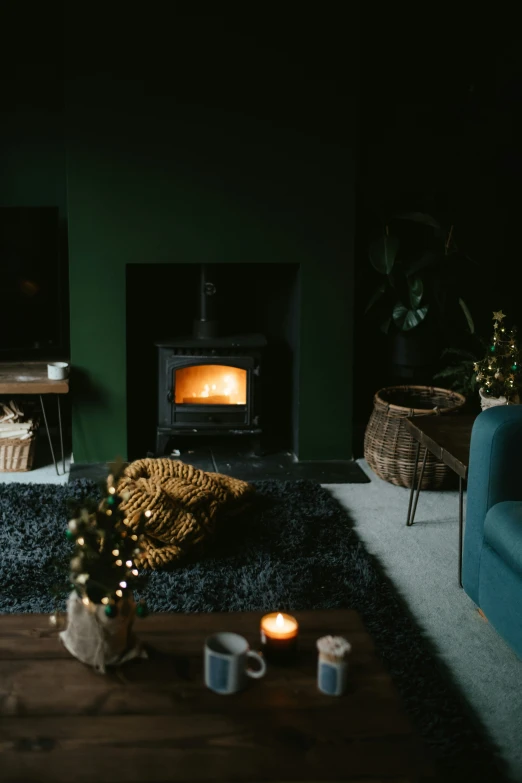 a room with dark walls, wood burning stove and couch