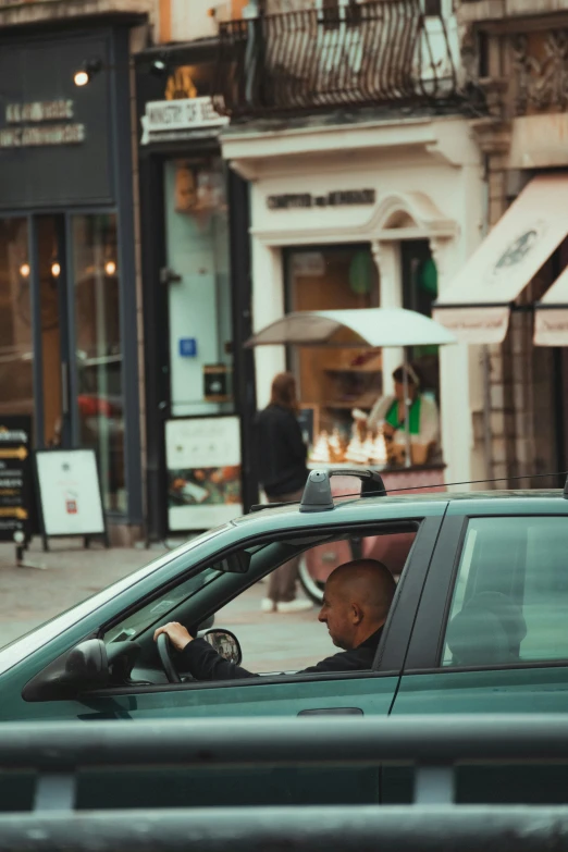 a man sits in the drivers seat of a police car