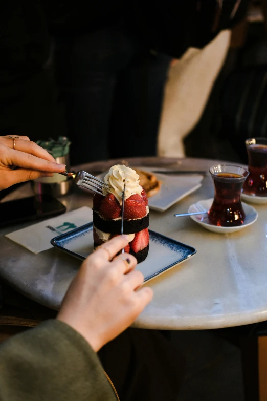 a person  into some dessert on top of a plate