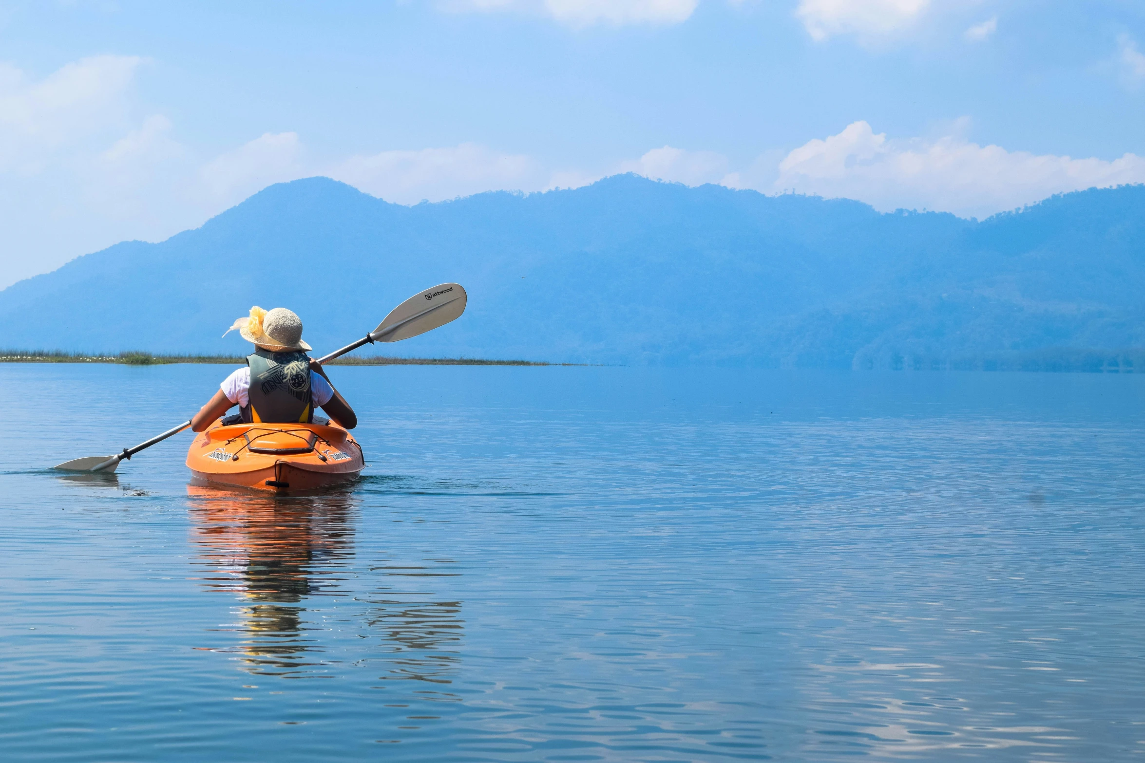 a person with a cowboy hat and in a kayak