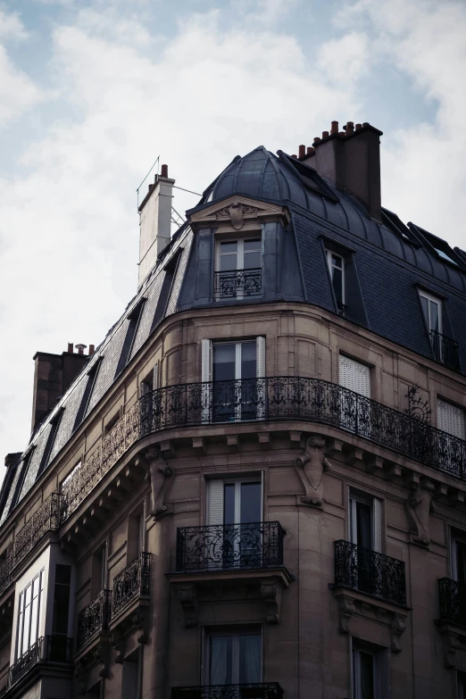 the top part of an old building with wrought iron railings