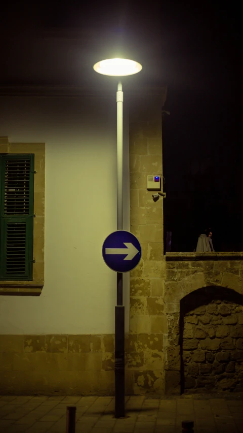 a street light sitting next to a road