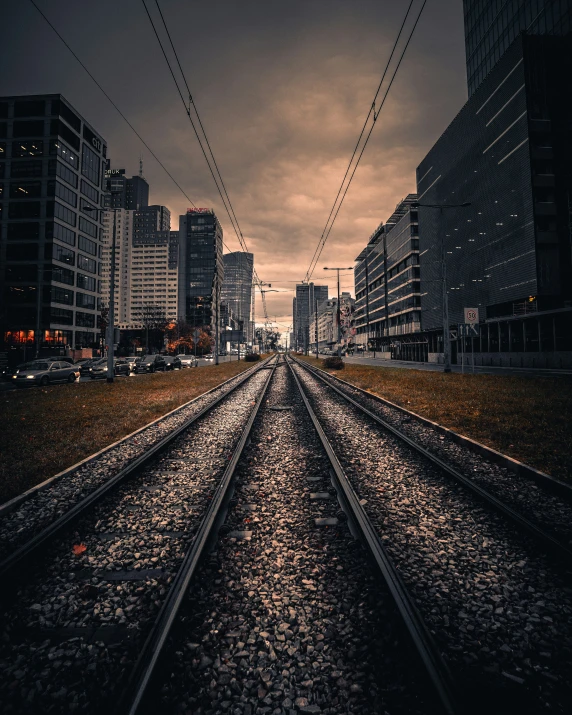 looking down on train tracks in the middle of an urban area