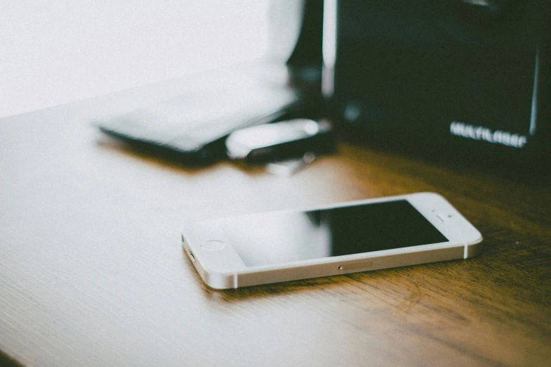 a phone with a camera next to it on a table