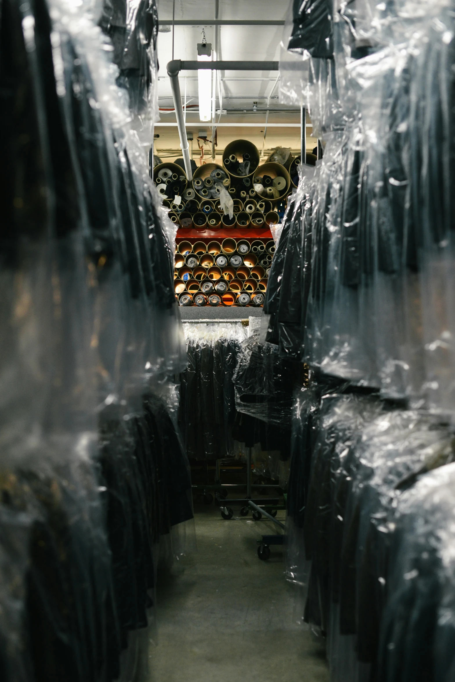 a large room with a wall filled with lots of black objects