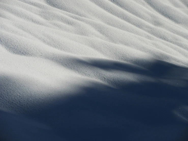 an interesting view of snow on top of the sand