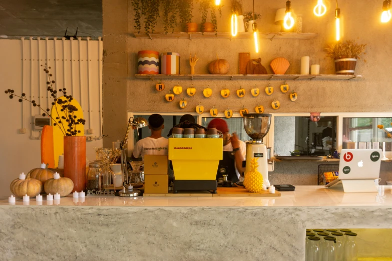 people are standing behind the counter in this coffee shop