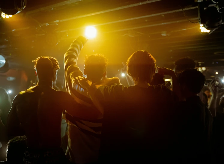 people in a room with light coming in from behind