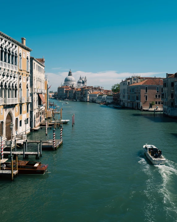 view over the water to a boat in front of buildings