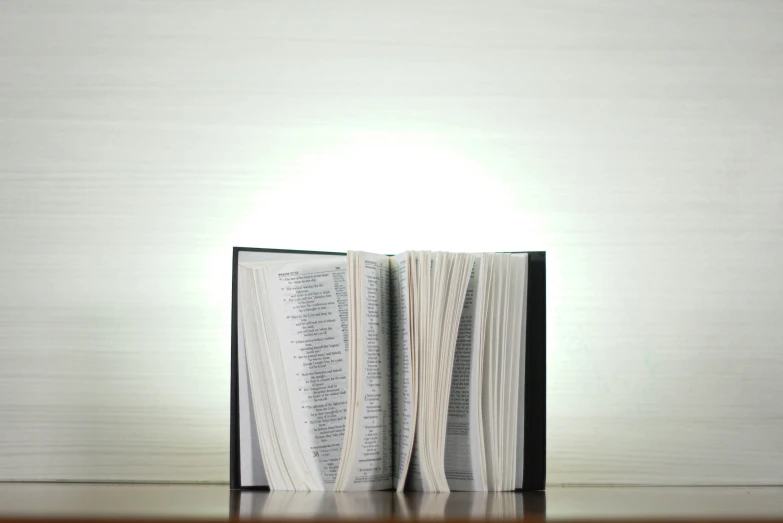 an open book sitting on top of a wooden table