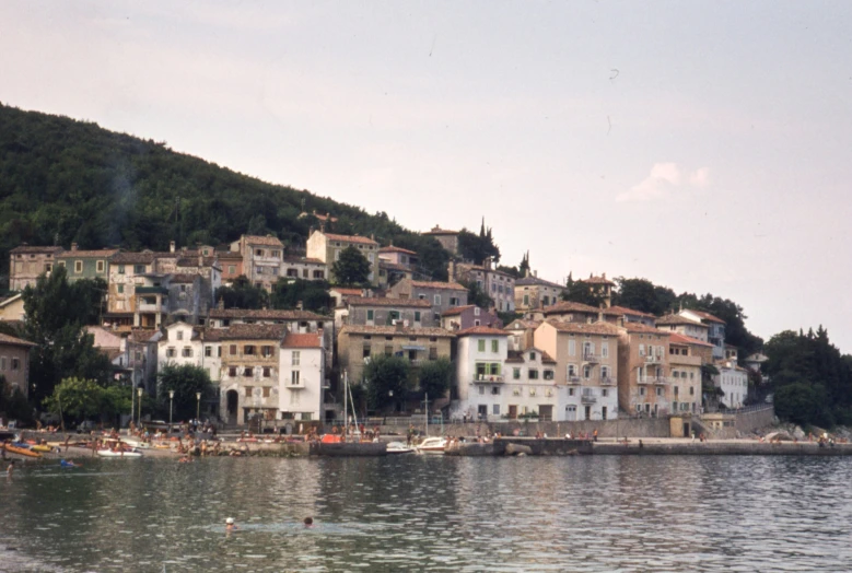 a small town sitting on top of a hill near the ocean