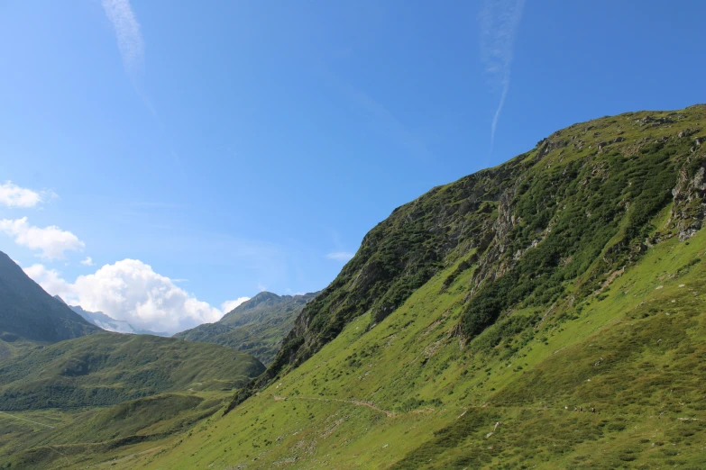 the view of a mountain side with several mountains in the background