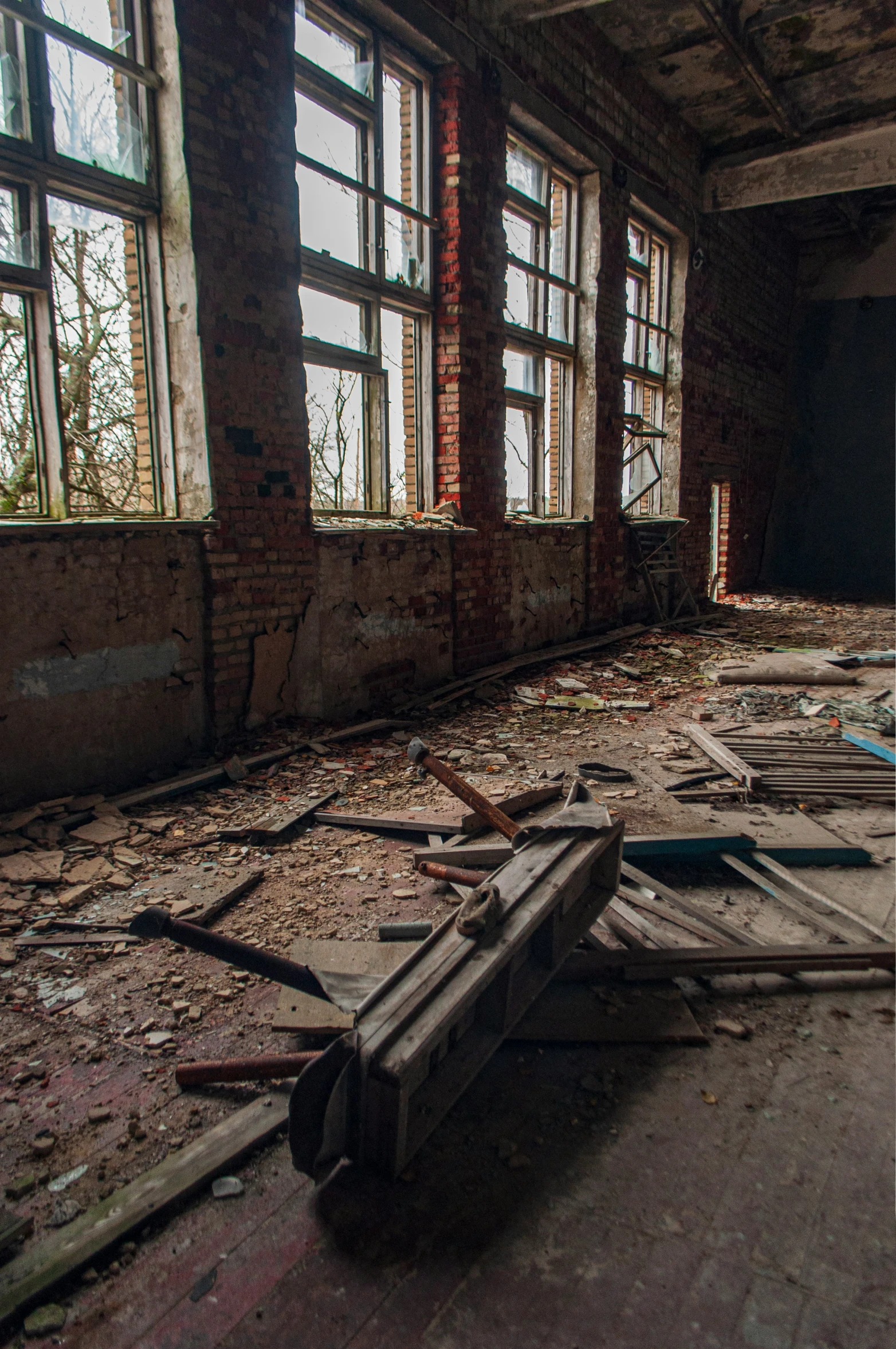 a large room with some windows that have broken apart