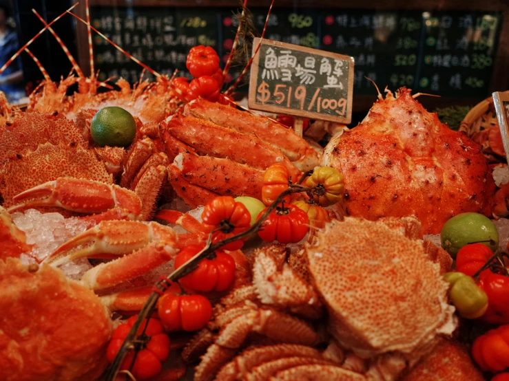 a counter covered with various types of food and signs