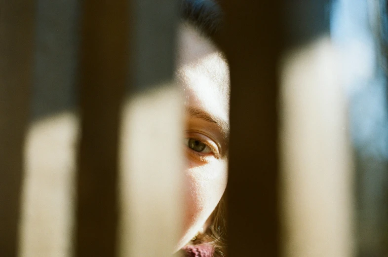 a girl is shown through a window in the light