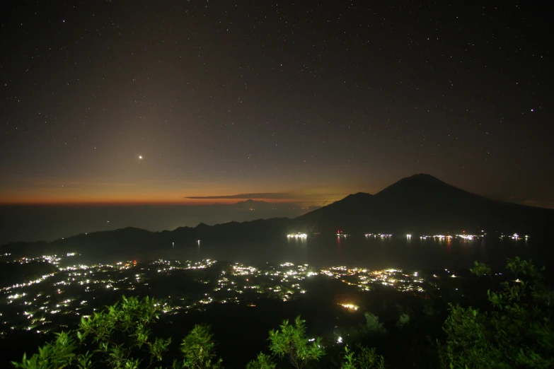 a city in the night with stars overhead