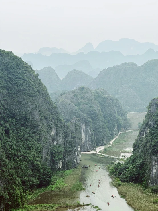 a large river surrounded by forest filled hills