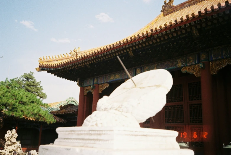 a tall building with lots of columns and sculptures