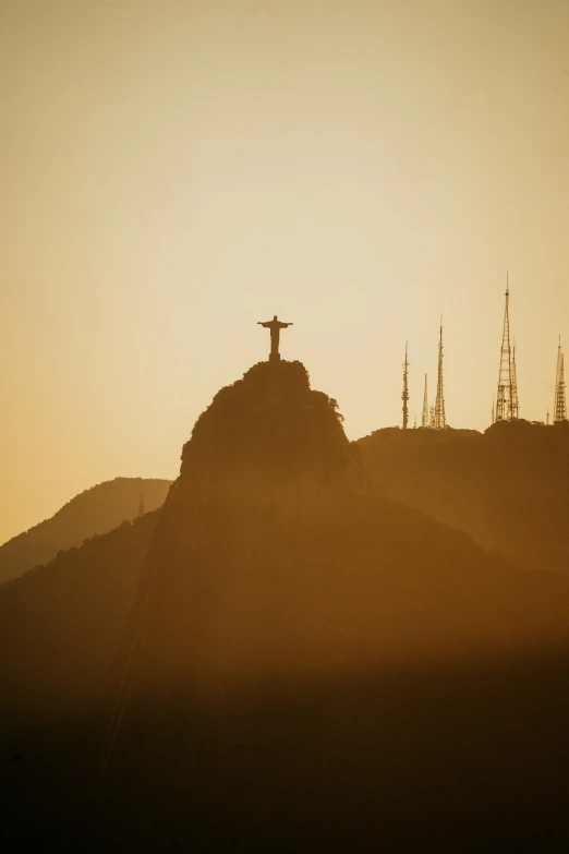 the silhouette of three hills with a cross at the top