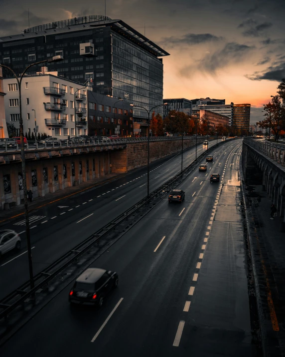 a city street with multiple vehicles and very tall buildings