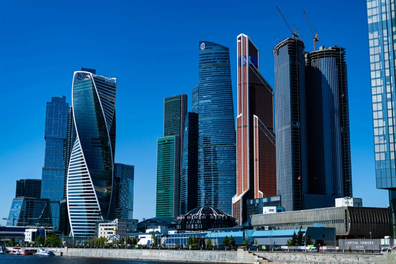 several tall buildings on the shore in the city