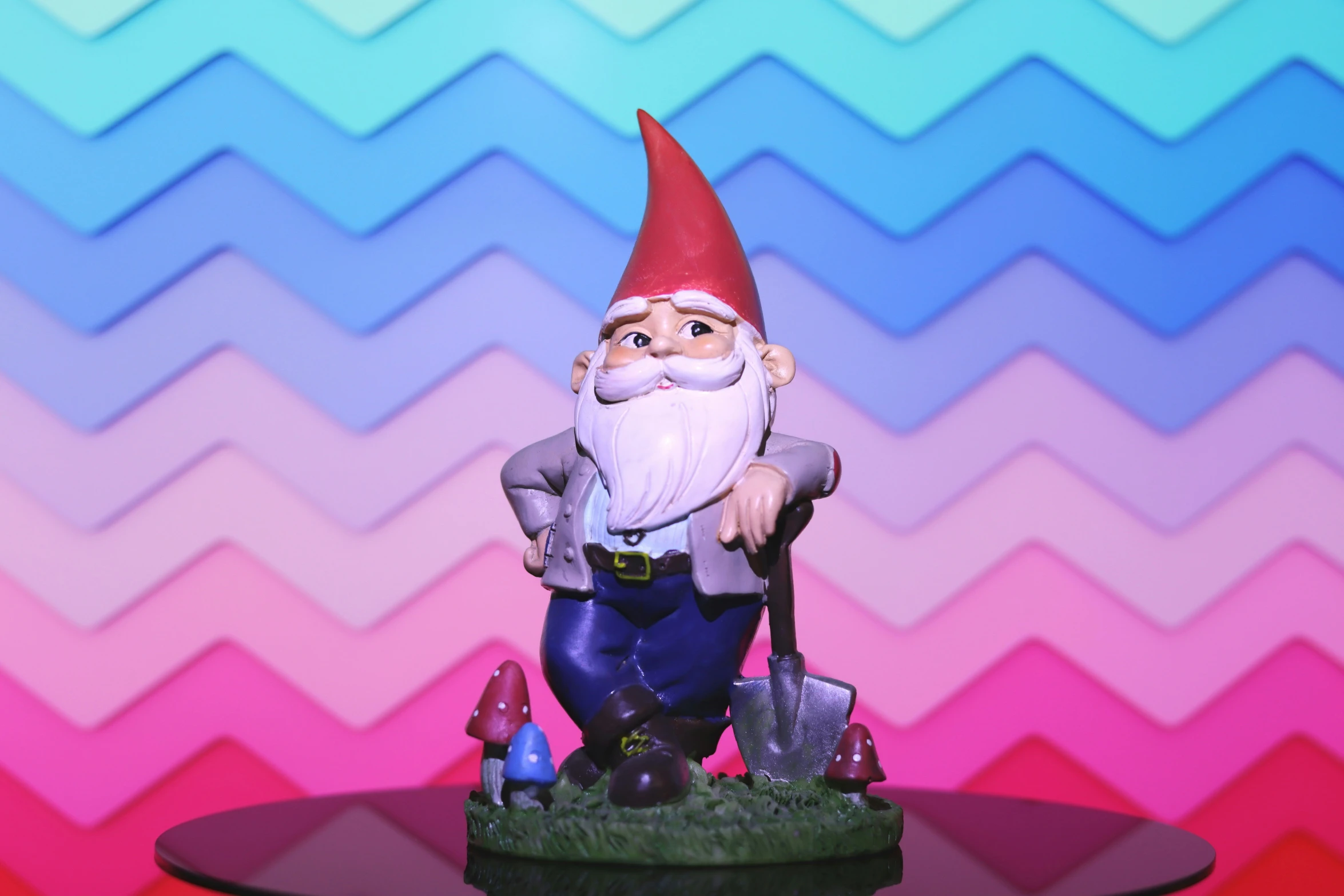 an odd looking gnome statue on top of a black table