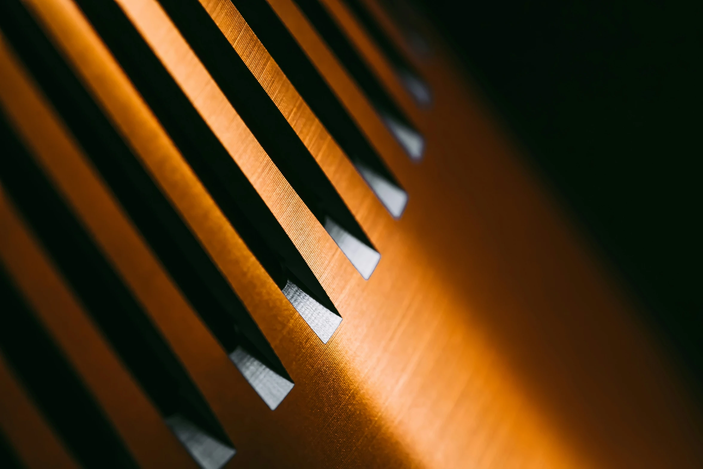 shadows from the slats of a wooden bench