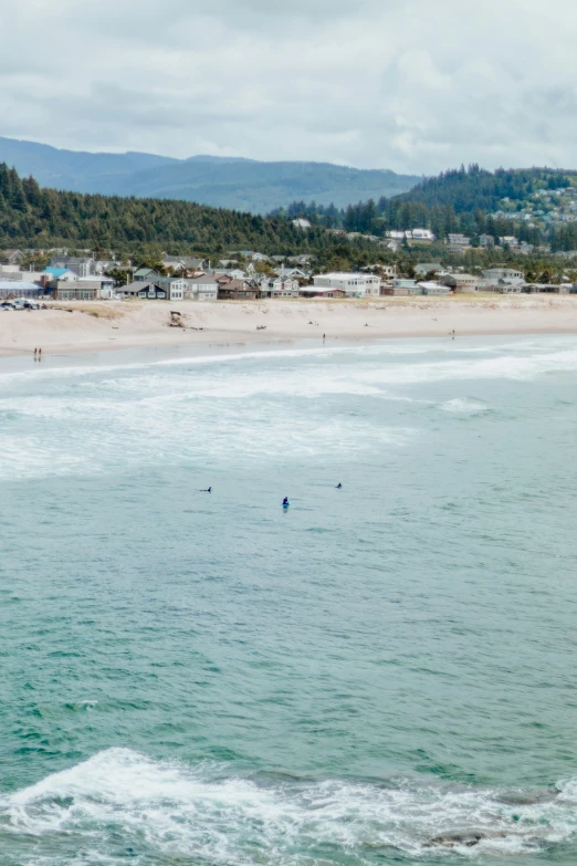 a man riding on the back of a surfboard on top of the ocean