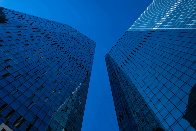 two tall buildings with blue sky in the background