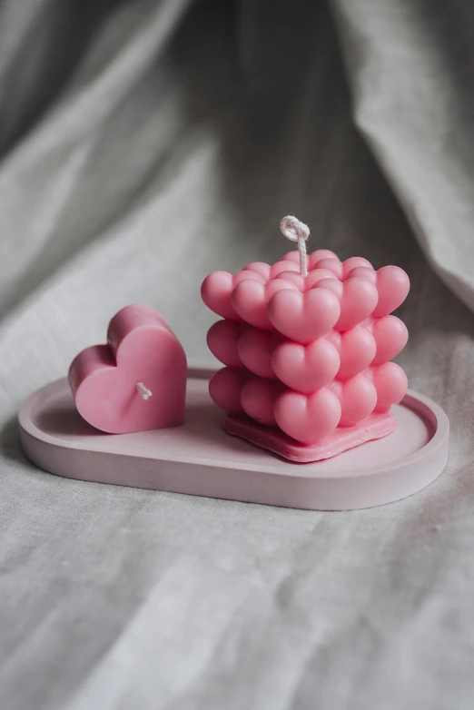 an unusual little pink sculpture made out of small plastic objects