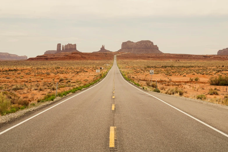 a highway near the desert and large mountains