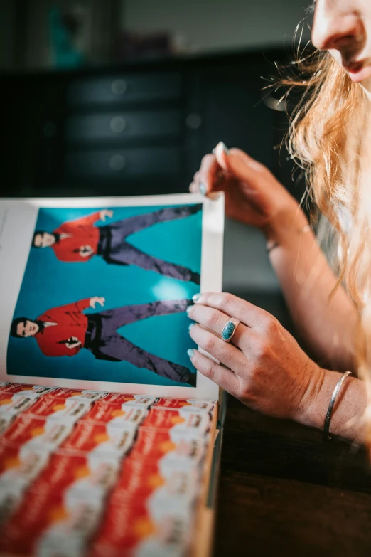 a woman is holding onto an old movie poster