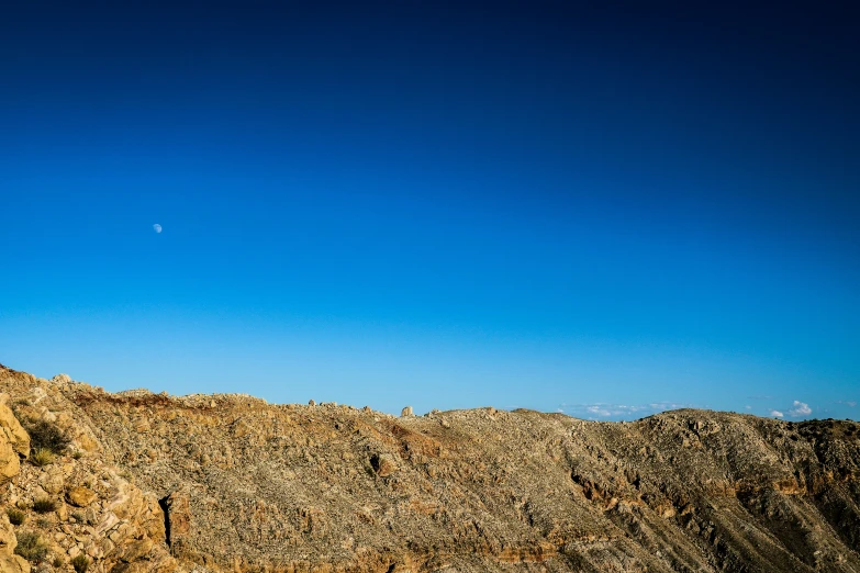 a person is on top of a mountain and is riding a horse