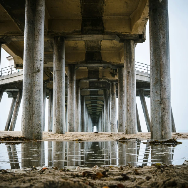 a long pier that has multiple rows of pillars