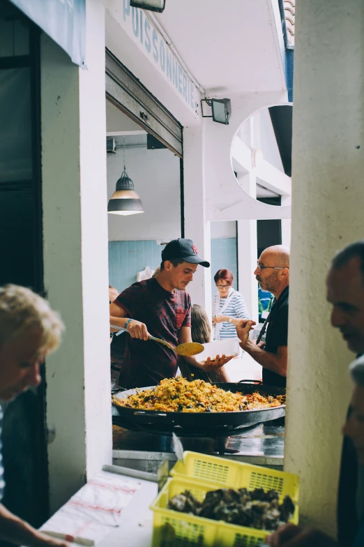 a man preparing food to sell at an outdoor restaurant