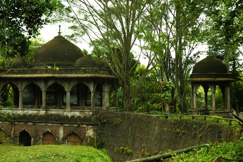 the gazebo is near a huge concrete wall