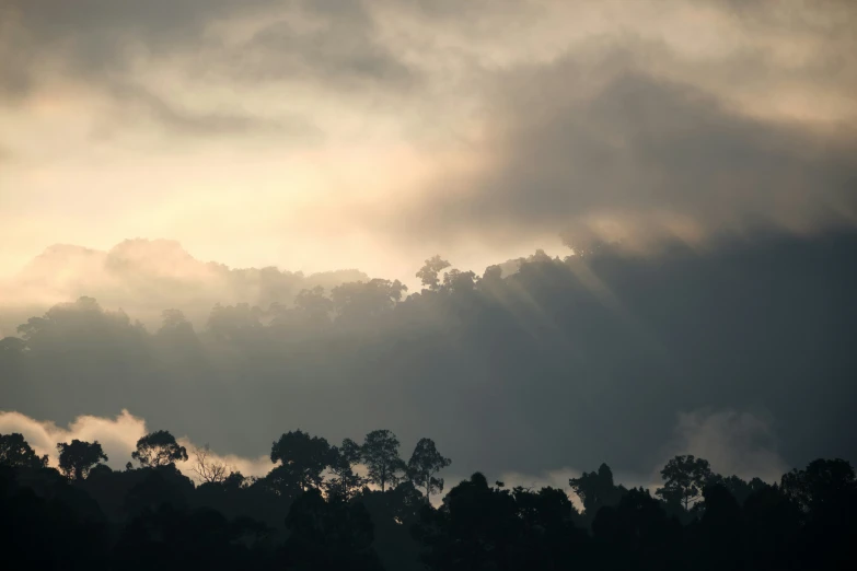 a sky is filled with clouds and sun rays