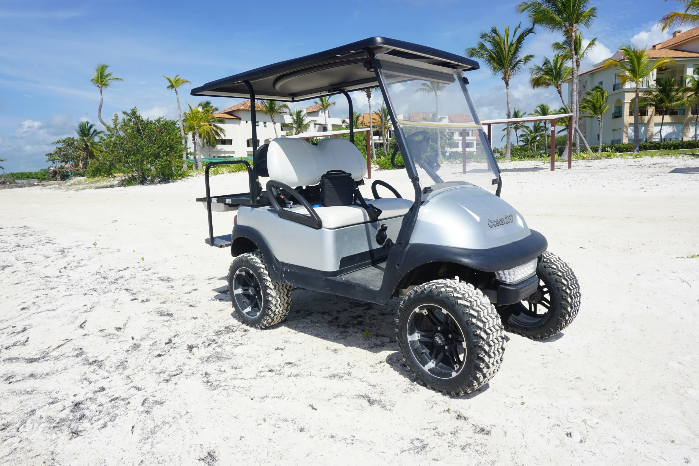 a club car on the beach with the back up to the front