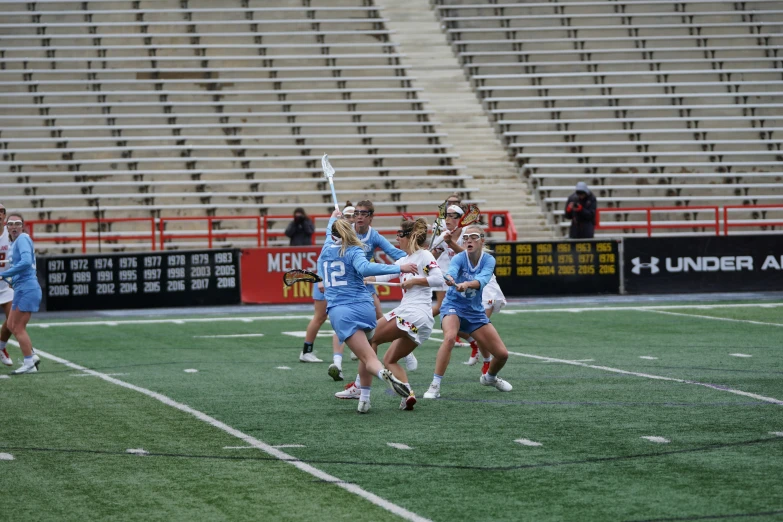 the girls are playing lacrosse on the field