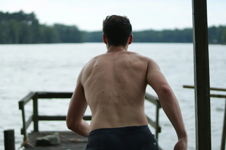 a man standing next to a body of water