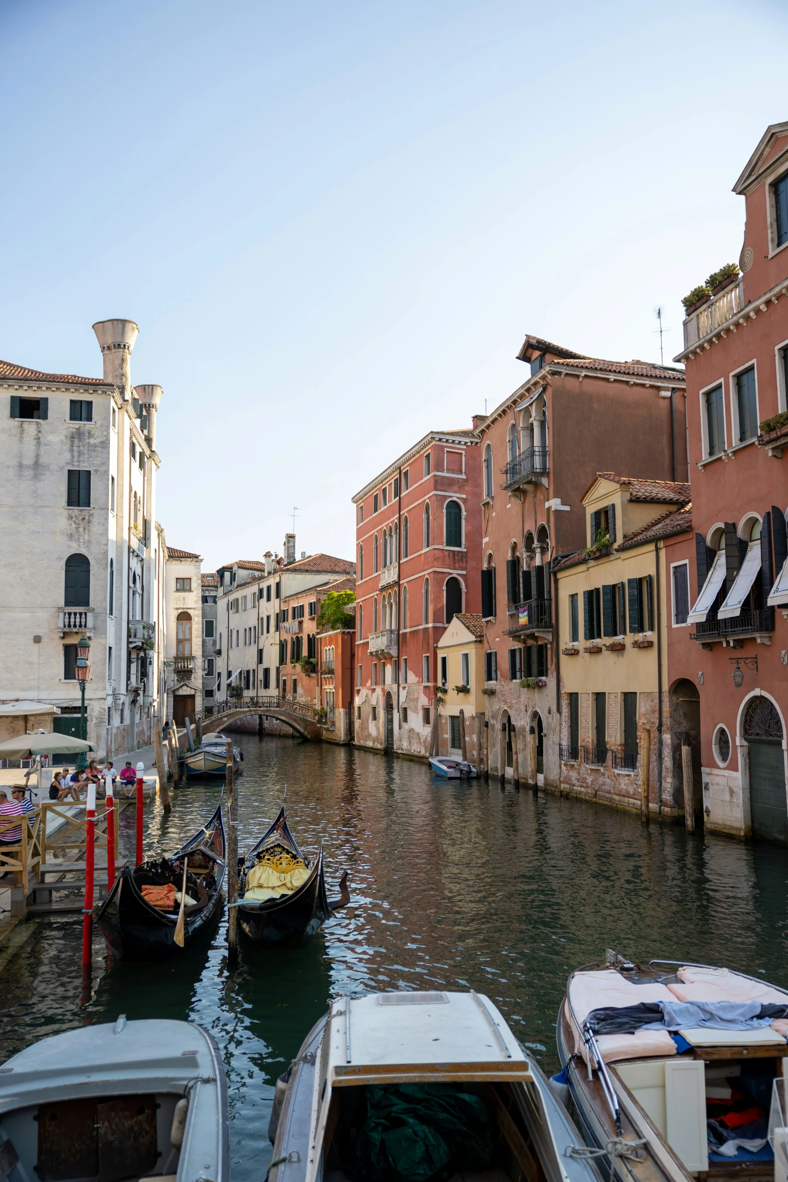 several boats tied to a dock in a canal